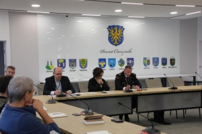 W sali konferencyjnej Starostwa Powiatowego w Cieszynie trwa spotkanie z udziałem przedstawicieli władz i służb. Przy stole siedzą m.in. Janina Żagan, bryg. Michał Pokrzywa oraz reprezentanci innych instytucji. W tle herby gmin Powiatu Cieszyńskiego.