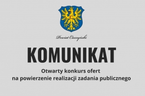 Grafika z szarym tłem, na górze Herb powiatu: orzeł złoty w polu niebieskim zwrócony w prawo, ukoronowany złotą otwartą koroną. Pod herbem napis: otwarty konkurs ofert na powierzenie realizacji zadania publicznego dotyczącego punktu interwencji kryzysowej